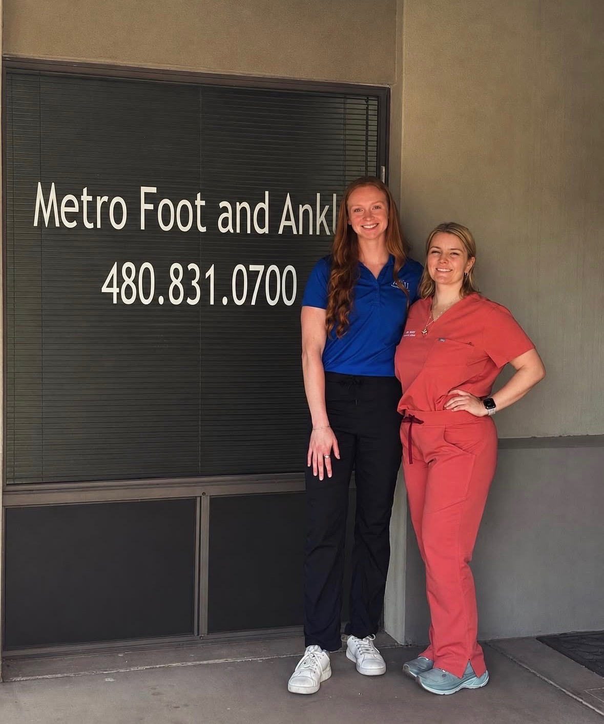 Metro Foot & Ankle staff outside the Suite 108 entrance in Tempe, showing office signage and phone number